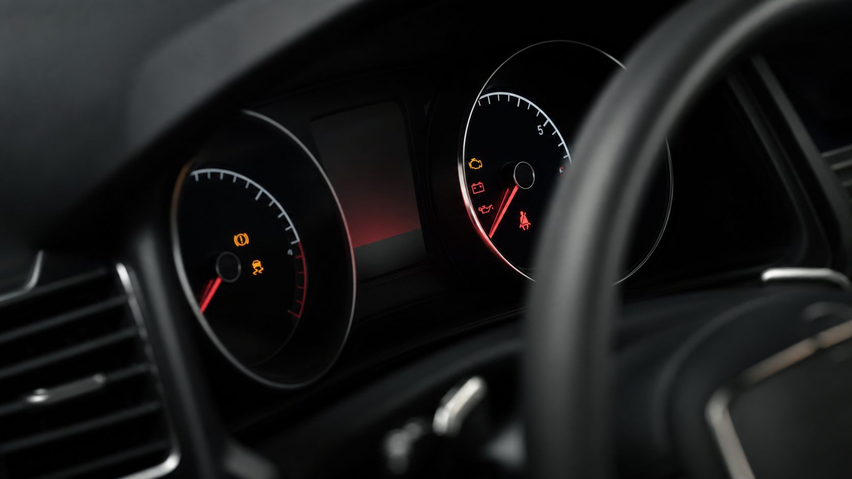 A car instrument cluster displaying several warning lights