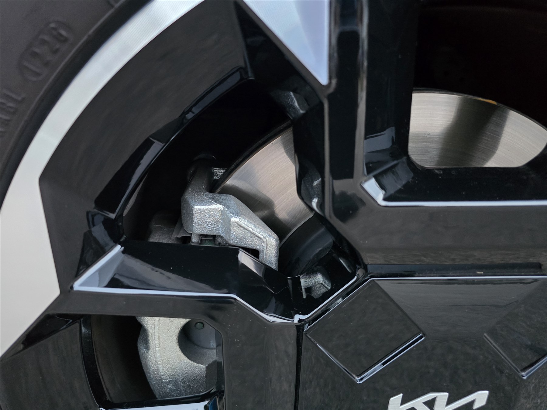 Brake disc and caliper visible through a modern car alloy wheel.