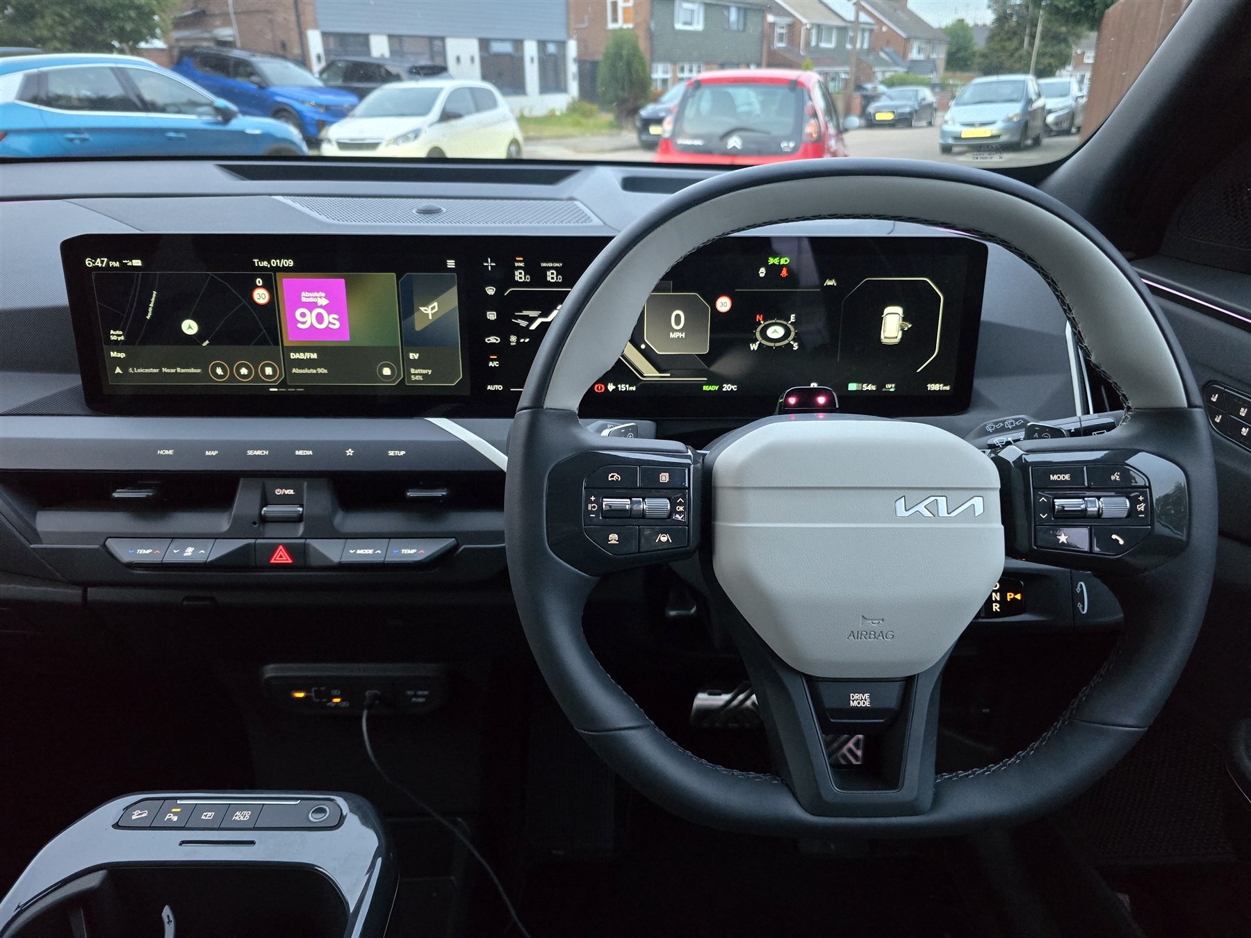 Modern car dashboard and infotainment display during a used-car equipment check.