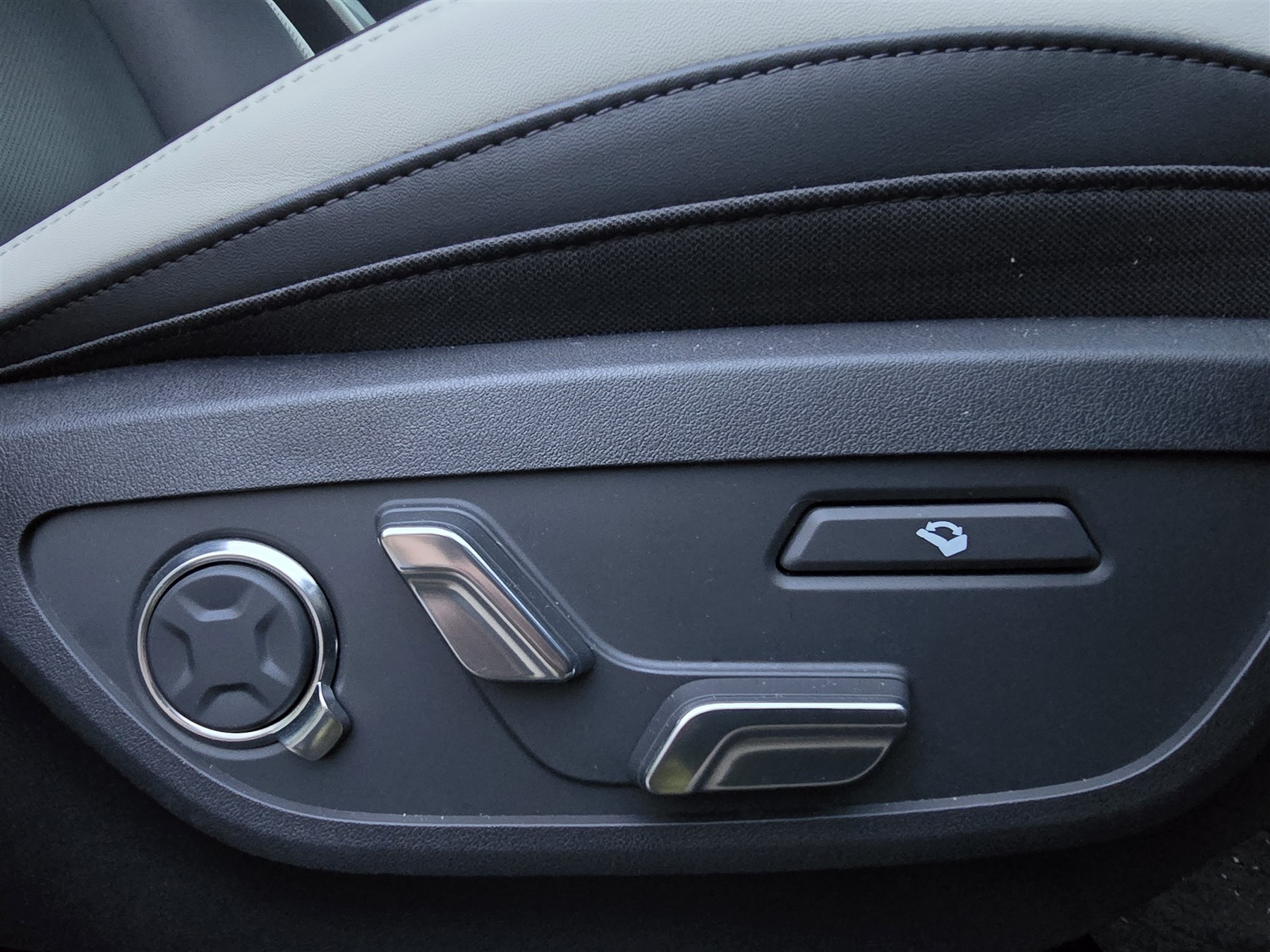 Electric seat controls fitted to a modern used car.