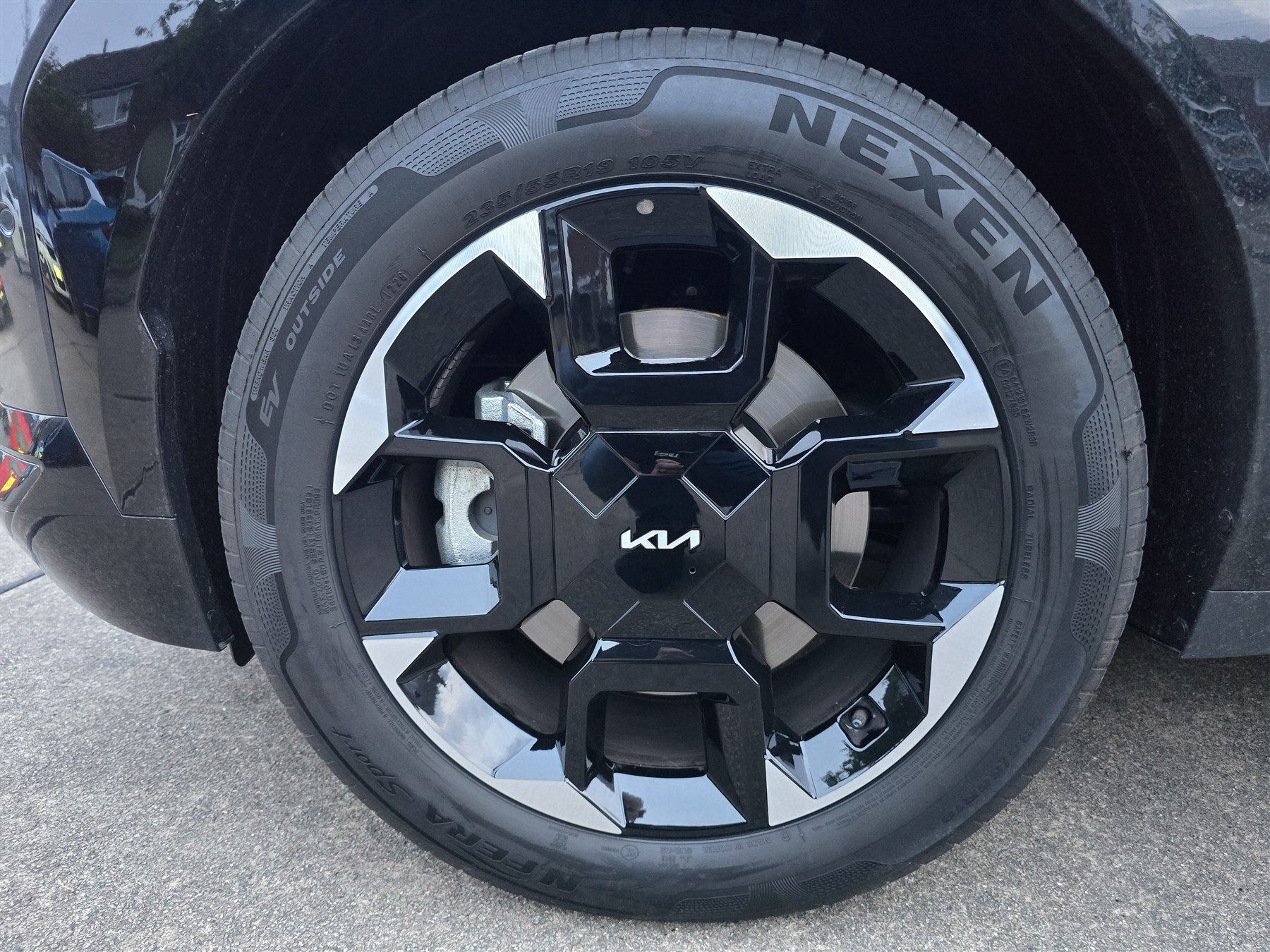 Alloy wheel, tyre and brake components viewed during a used-car inspection.