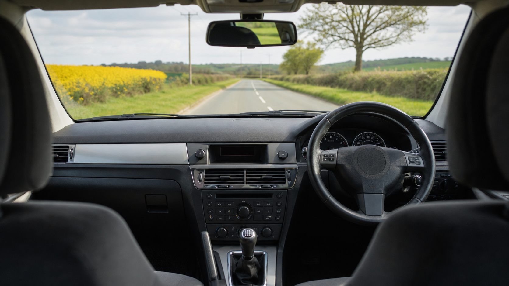 Right-hand-drive car interior on a quiet British test-drive route
