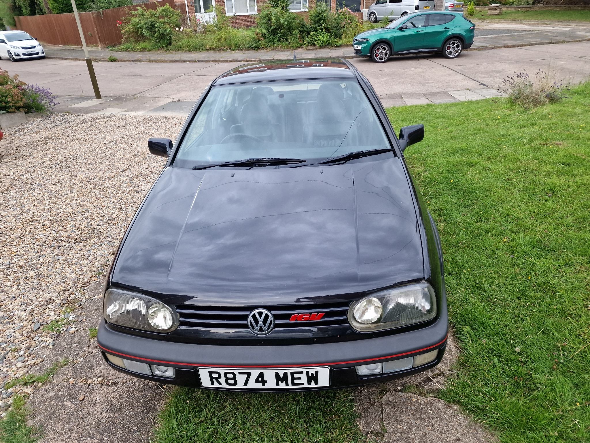 Black Volkswagen Golf photographed straight on from the front